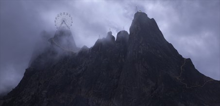 Ferris wheel on rocky mountaintop