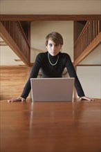 Caucasian woman using laptop on table