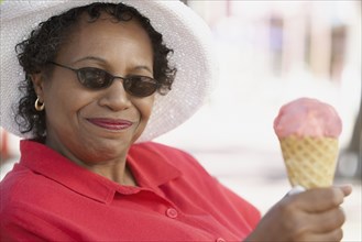 Middle-aged African woman with ice cream cone