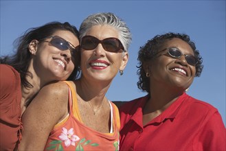 Three middle-aged women smiling