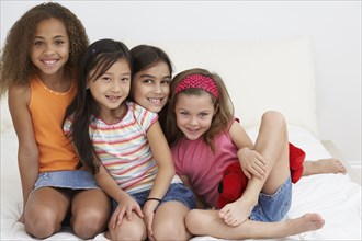 Group of young girls hugging and smiling