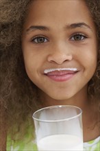 Close up of African American girl with milk mustache