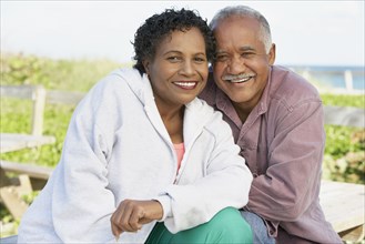 Senior couple smiling and hugging outdoors