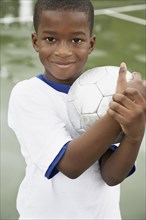 African American boy holding soccer ball