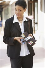African businesswoman holding wallet open