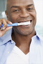 African American man brushing teeth