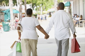 Multi-ethnic couple holding hands