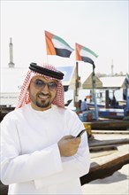 Arab man holding cell phone