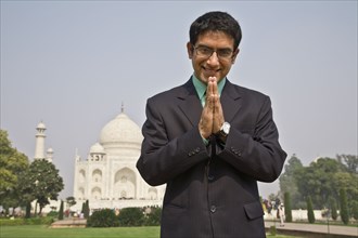 Indian businessman praying at the Taj Mahal