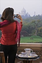 Woman taking photograph of the Taj Mahal