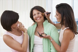 Sisters giving mother a makeover