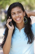 Hispanic teenager talking on cell phone