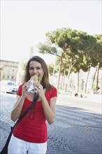 Woman eating sandwich outdoors