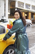 Korean woman with gifts taking taxi