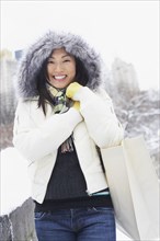 Korean woman walking with bag in snow