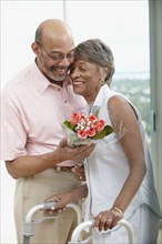 African man giving wife flowers