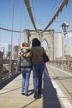 Italian couple crossing Brooklyn Bridge
