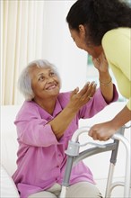 African American woman helping senior mother