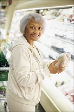 Senior African American woman shopping in grocery store