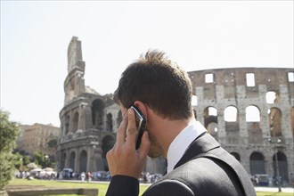 Italian businessman talking on cell phone outdoors