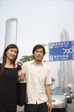 Chinese couple walking in urban area