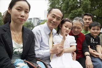 Chinese family sitting together outdoors
