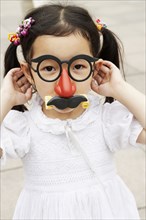 Chinese girl wearing mask with eyeglasses and mustache