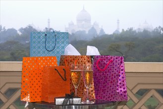 Group of luxurious shopping bags on table with Champagne