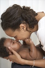African American mother caressing baby
