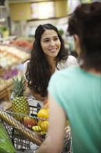 Women talking in grocery store