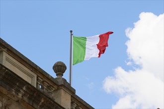 Italian flag fluttering on rooftop