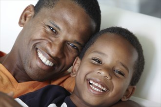 Smiling African American father and son