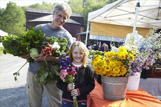 Father and daughter buying flowers at farmer's market