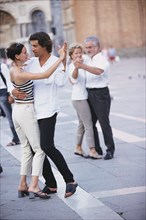 Couples dancing in town square