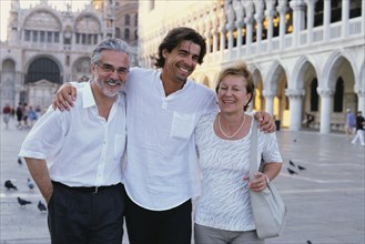 Parents and son walking in St. Mark's Square
