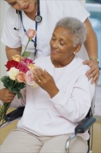 Senior patient getting flowers in hospital