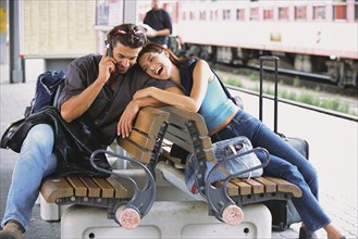 Couple relaxing at train station