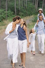 Caucasian family walking in park