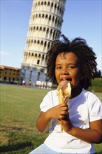 Girl eating ice cream outside Leaning Tower of Pisa