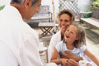 Caucasian family relaxing on patio