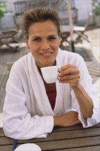 Caucasian woman drinking coffee outdoors