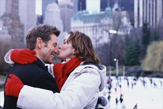 Couple kissing outside Rockefeller Center