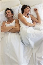 Couple arguing in bed