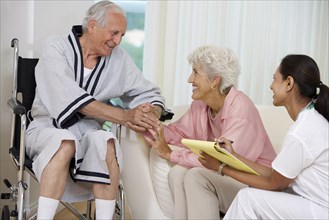 Nurse talking to Senior couple at home visit