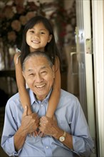 Senior man and granddaughter hugging