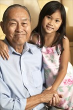 Senior man and granddaughter holding hands