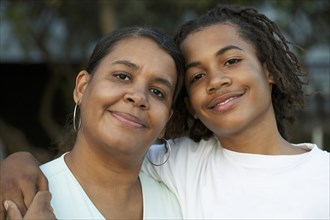 Mother and son hugging outdoors