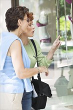 Senior women window shopping together