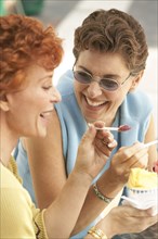 Senior women eating ice cream together
