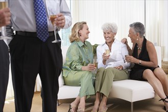 Senior women talking on sofa